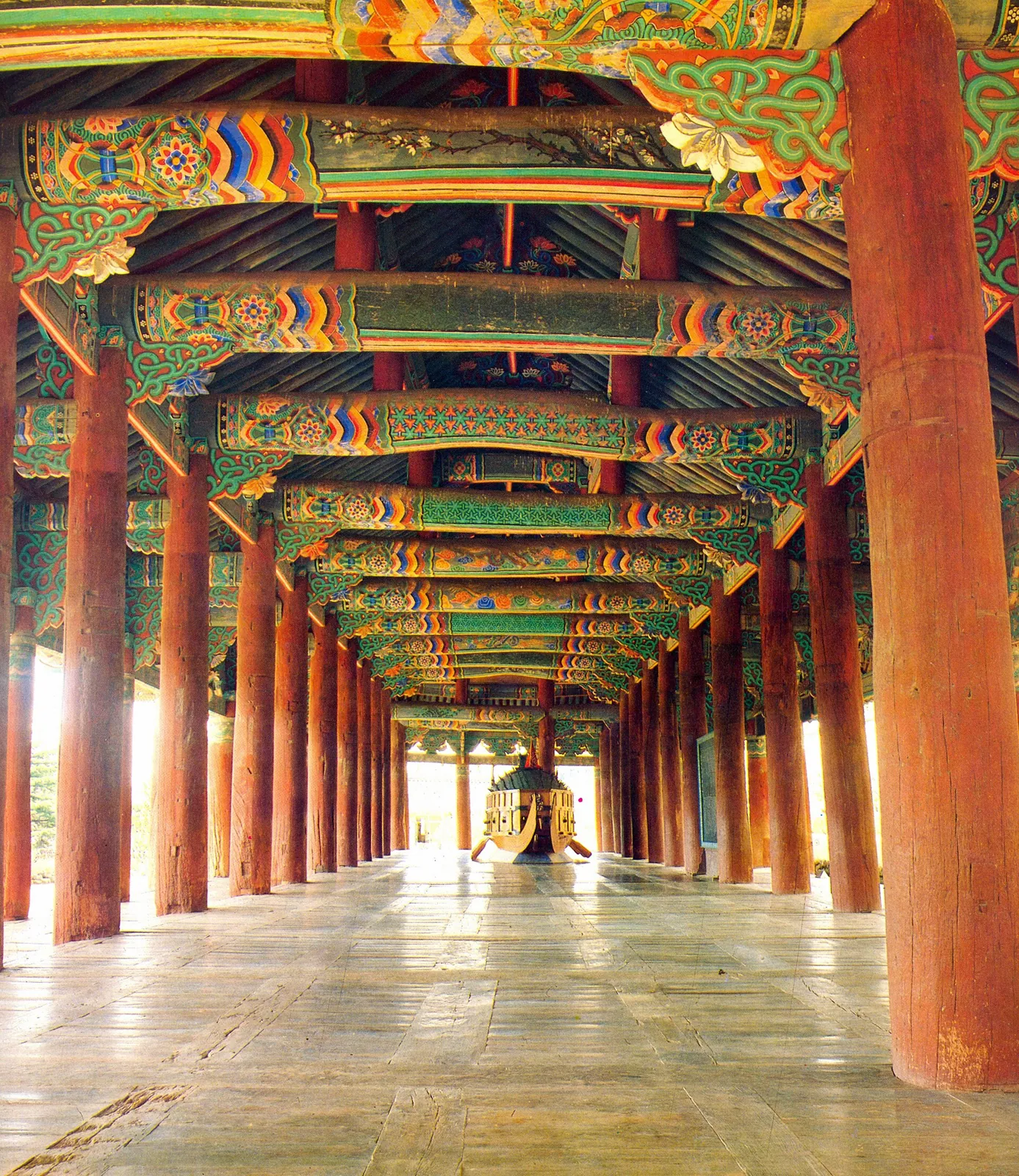 Long painted wooden hall with red pillars and colourful beams at Jinnamgwan in Yeosu