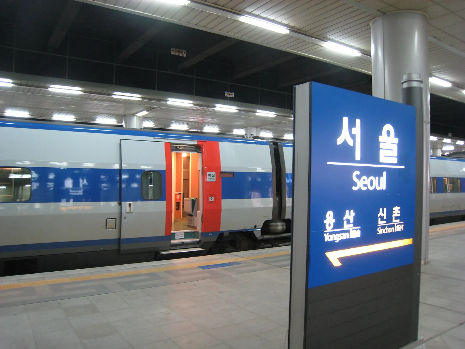 KTX train at a Seoul Station platform beside the station name sign