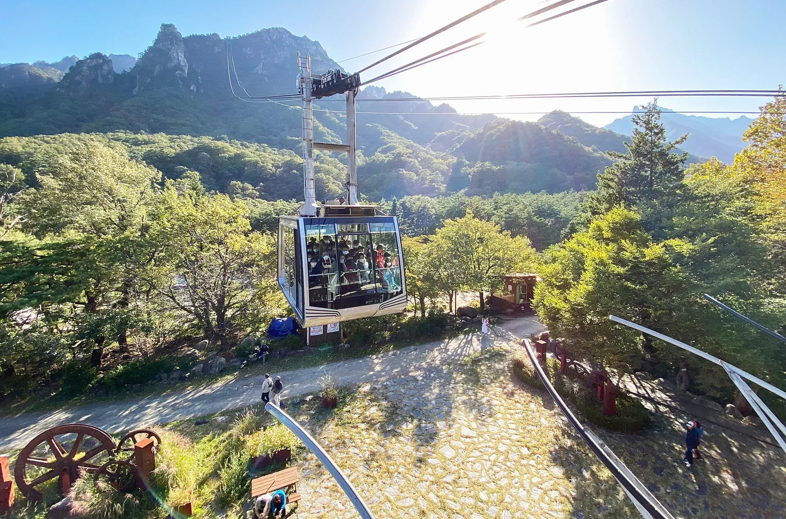 Seorak cable car cabin rising toward granite peaks in bright sun